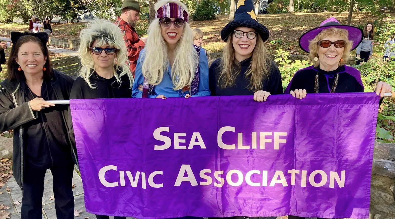 Costumed volunteers with the Sea Cliff Civic Association banner at the Halloween Parade