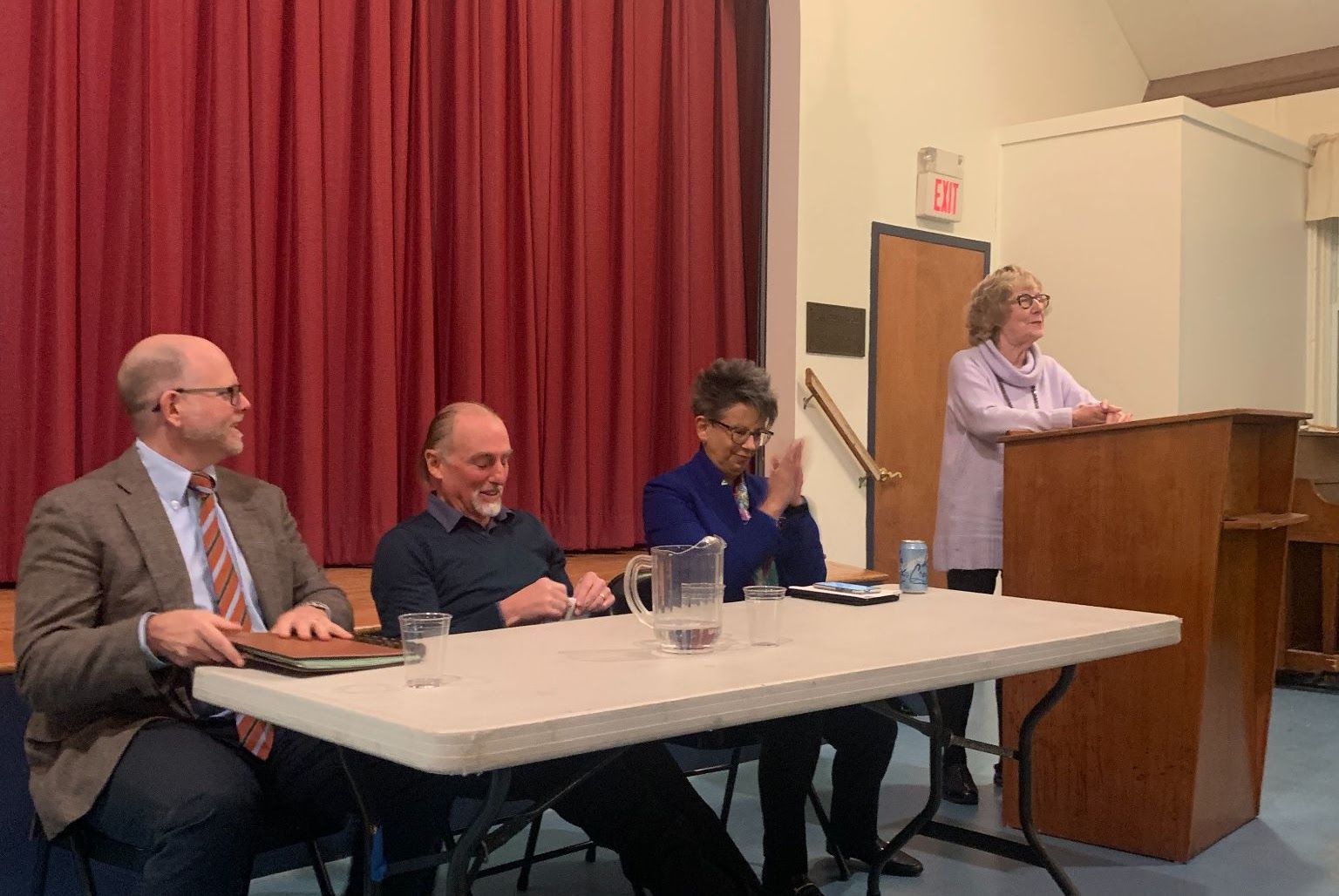 Candidates seated at a table during Meet the Candidates