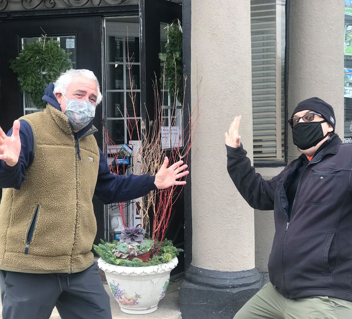 Two scavenger hunt players posing outside a house