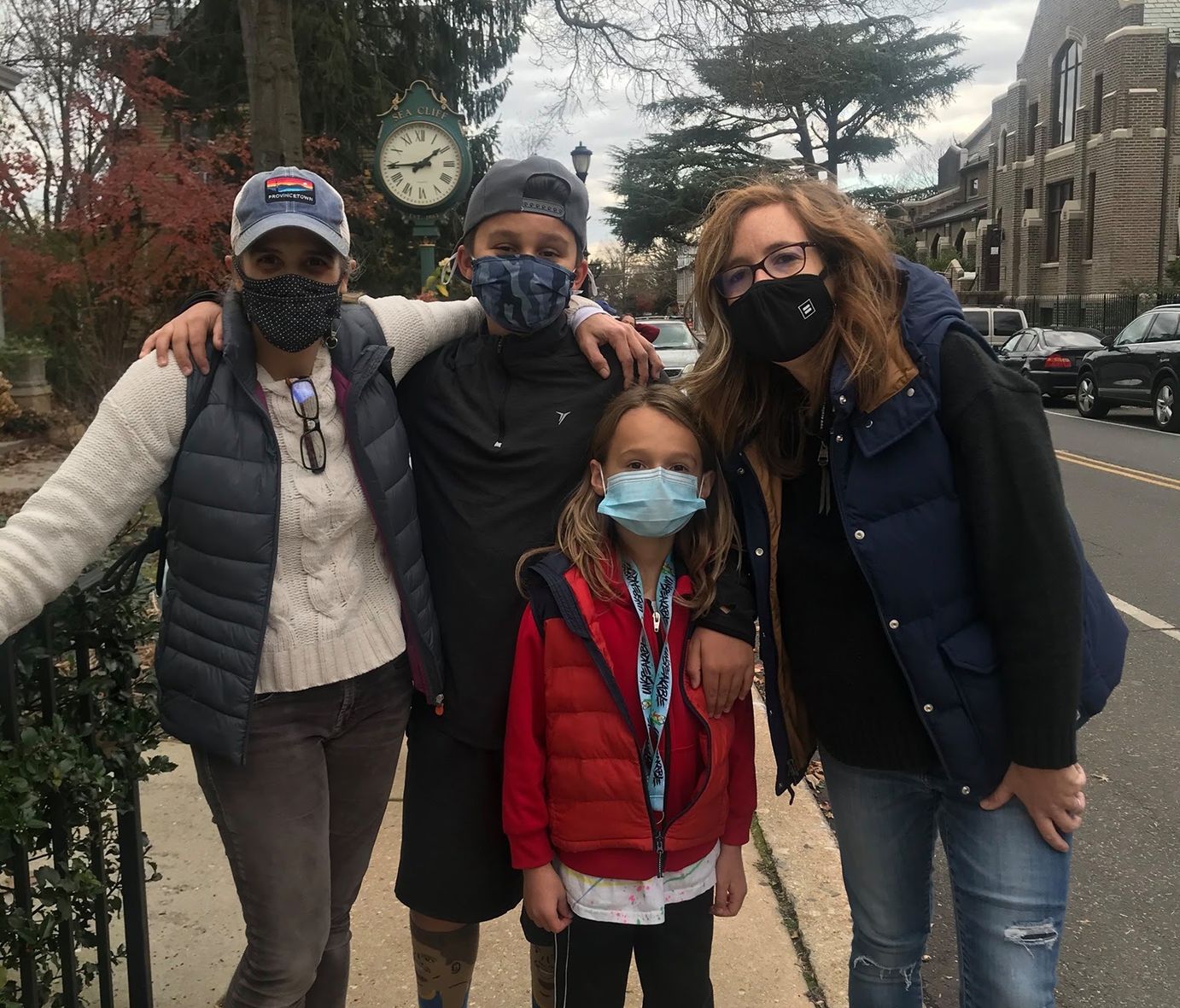 A team posing on a village sidewalk during the Thanksgiving Scavenger Hunt