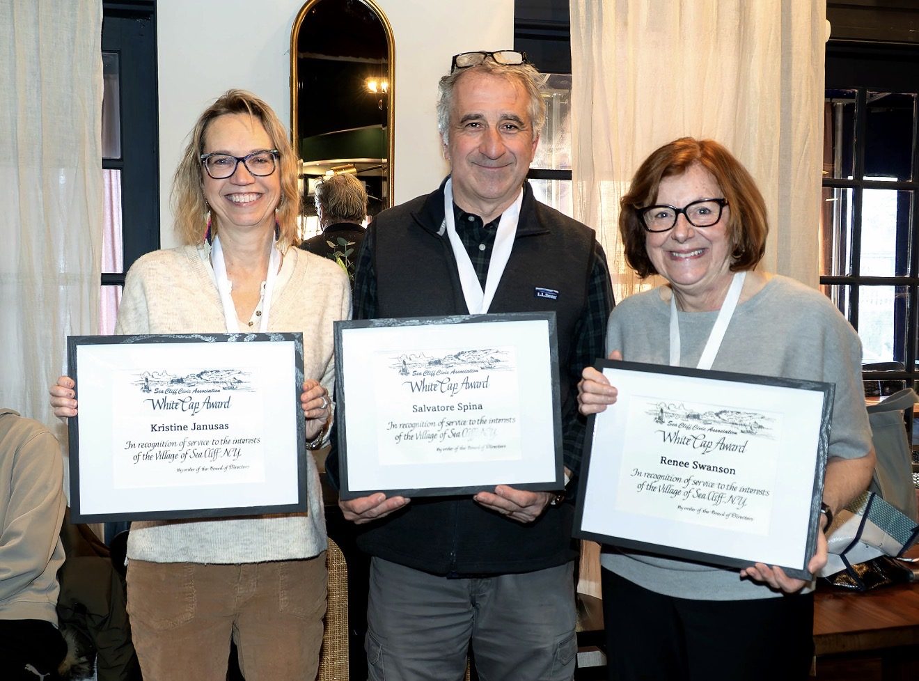 2025 White Cap honorees Kristine Janusas, Salvatore Spina and Renee Swanson holding their White Cap Award certificates