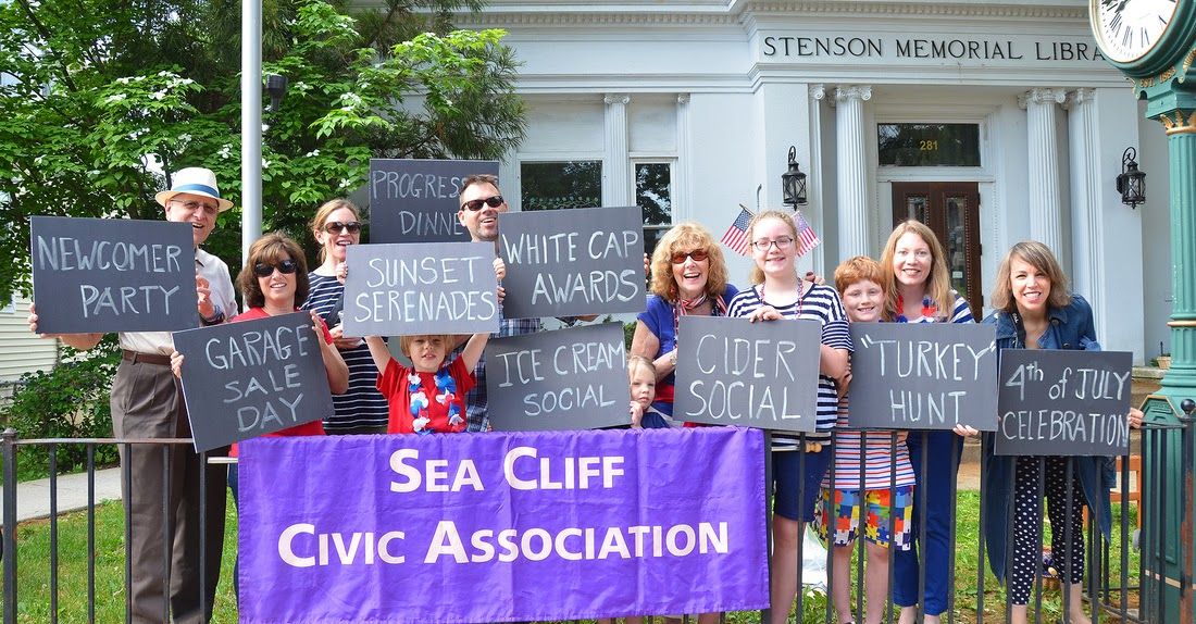 Sea Cliff Civic Association members outside Stenson Memorial Library holding signs for village events